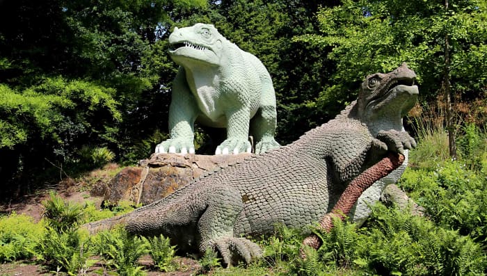 Two Iguanadons. The front specimen is posed on a model Cycad branch, reflecting the vegetation of the Jurassic