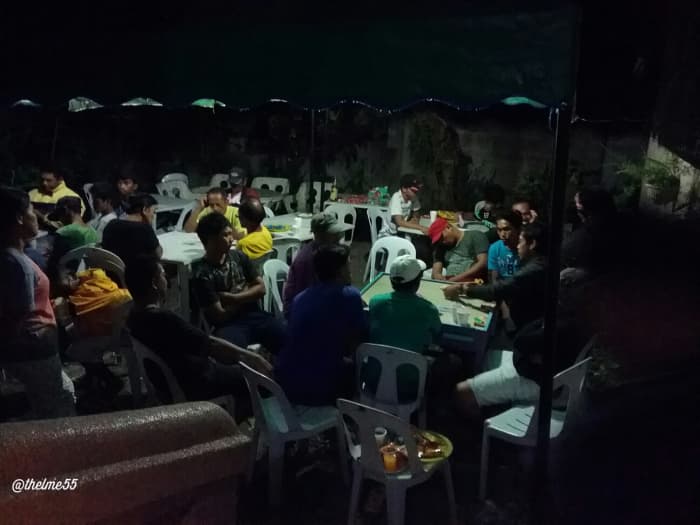 The vigil outside the house. Relatives, friends and neighbours played card games to kill the time during the vigil.