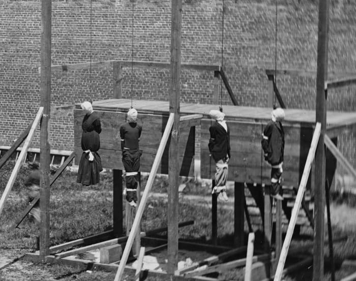 The execution of Mary Surratt, and her three co-conspirators. From left to right: Mary Surratt, David Herold, Lewis Powell, and George Atzerodt