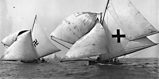 Two yachts sailing in Sydney Harbour Australia, c1926. One carries a conventional cross as a decorative motif, but look at the one on the left