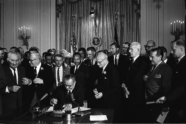 President Lyndon B Johnson signing the Civil Rights Act 1964 with Martin Luther King looking on. The Act was a tremendous achievement for King, but did not mean that he stopped his work.