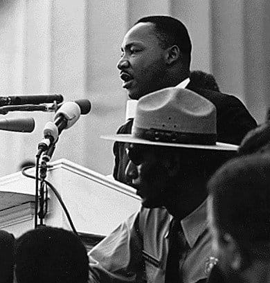 MLK making his famous "I have a dream" speech. The speech took place in 1963 and was delivered to a quarter of a million people in Washington DC.
