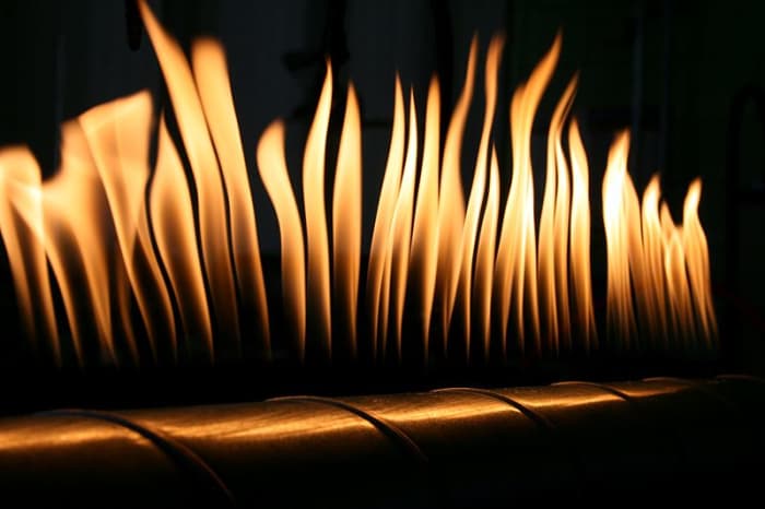 This metallic tube named after Heinrich Rubens has a long line of small holes in which propane is sparked up to get a long row of uniform flames. When a speaker is placed at one end, the compression and rarefaction create pressure difference.