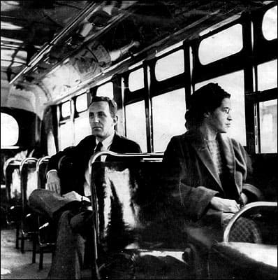 Rosa Parks traveling on a Montgomery bus on the day that the transport system was officially integrated. Parks became an icon of the civil rights movement but also suffered hardships. She lost her job in Montgomery and received many death threats.