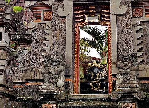 Above top: Two types of gates - paduraksa (left) and candi bentar (right). Above bottom: Stone carvings cover the door frame of this paduraksa gate.