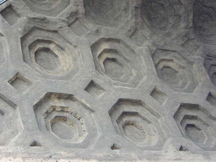 The Romans invented concrete by mixing their lime based mortar with pebbles, fragments of stone and pottery. As can be seen here in the vaulting of the Roman building, the new material allowed an expansion in architectural design.