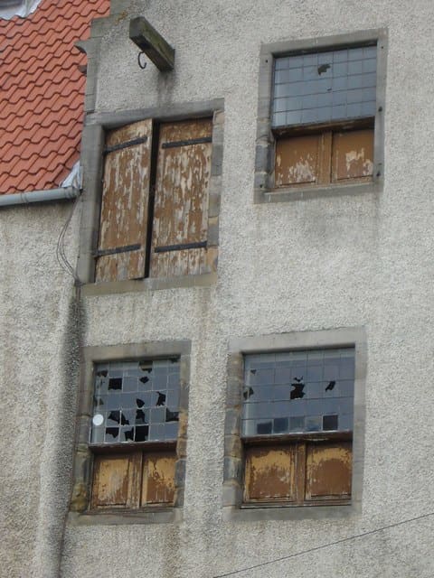 In medieval Europe, wooden shutters were often used not only to protect houses from the worst of the weather when glass could not be afforded, but also to protect the glass during times of social unrest or warfare.