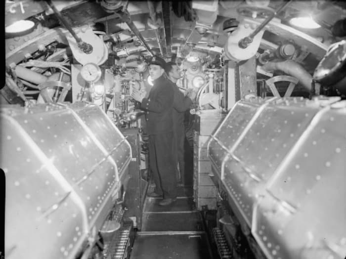 WW2: Two Royal Navy stokers in the engine room of a British submarine during World War II.