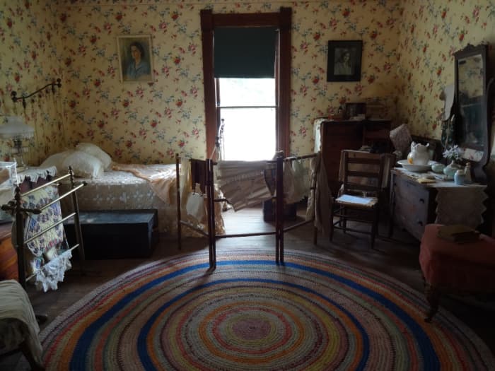 Room and board provided supplemental income for the household. Washbasins, rag rugs, hand made quilts, all products of the time.