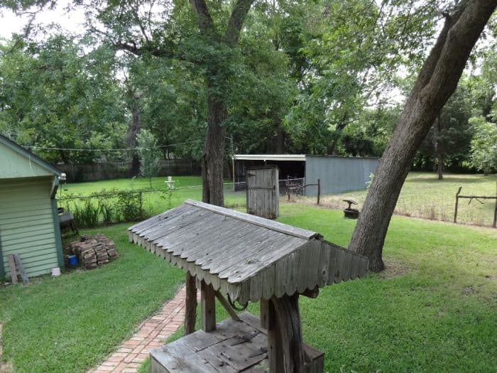 The covered well along the path is on the way to the outhouse which was used before indoor plumbing was installed.