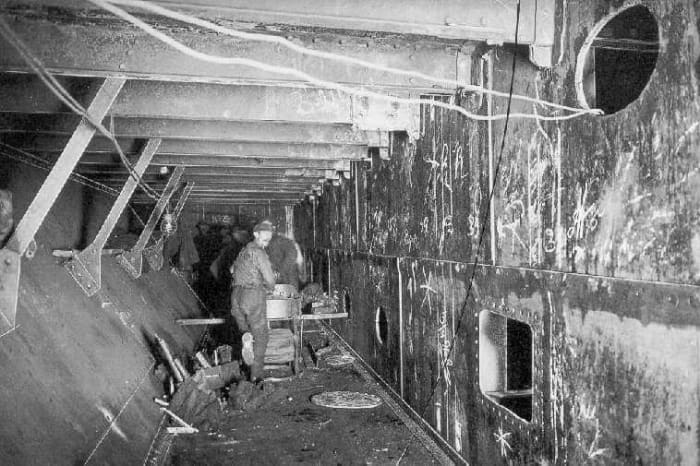 This photo of Olympic undergoing her 1913 refit shows the construction of her inner skin double hull. The result is a watertight puncture zone.