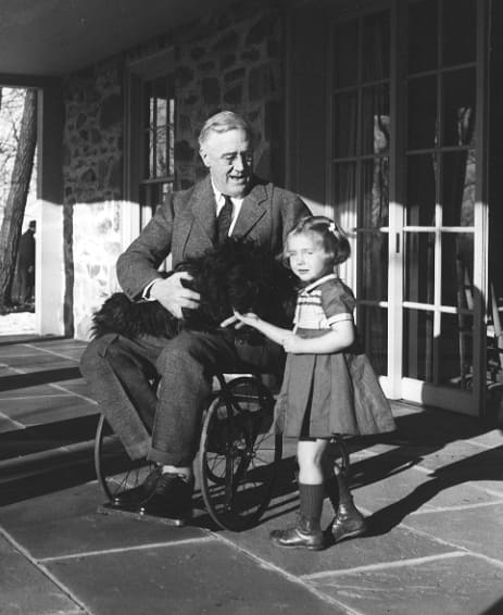 Rare photo of Franklin D Roosevelt in a wheelchair in 1941. FDR took decisive and radical action to counter the economic decline in the USA. Within a year the American economy was beginning to show signs of economic recovery.