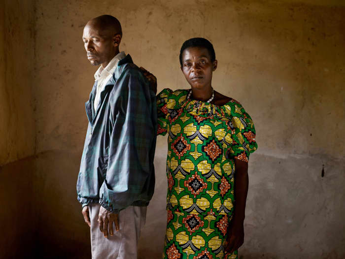 Jean Pierre Karenzi, a perpetrator (left) and Viviane Nyiramana, a survivor (right) pose for photographer Pieter Hugo after the genocide