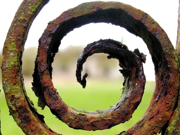 When oxygen in the atmosphere combines with iron and steel, it forms a chemical compound called rust. The chemical name is iron oxide. For protection we paint metal or use a coating of a metal called zinc. This is known as galvanization.