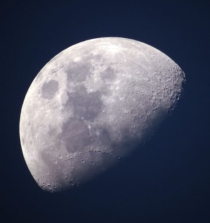 The Moon has no atmosphere and is covered in craters caused by asteroid impacts. It is approximately 238,000 miles or 384,000 km from our planet Earth.