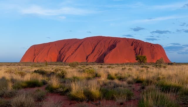 Ayer's Rock in Australia is made of sandstone which is a sedimentary rock.