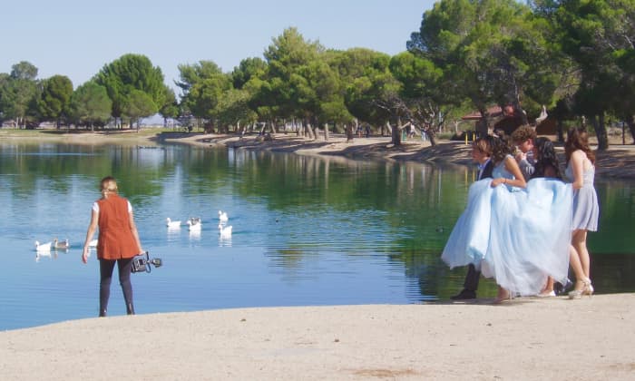 This photograph is of Apollo Park—a reclamation pond in Lancaster CA. Here you see preparations to photograph a quinceanera party. This photo could be used to emphasize the pros of designing a reclamation pond to also act as a public park.