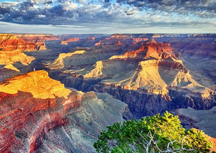 Grand Canyon: Standing on the rim of the Grand Canyon looking out over the endless ridges of colorful cliff walls and deep ravines.