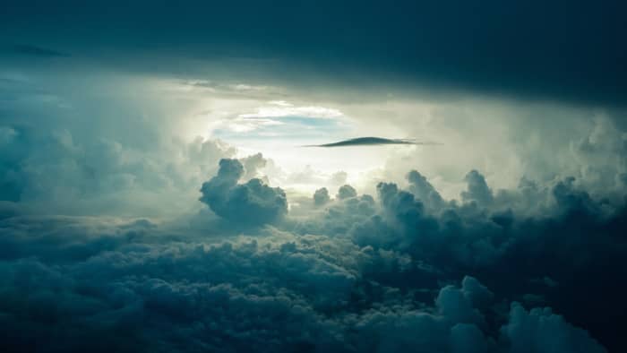 "Caduto dalle nuvole" translates to "fallen from the clouds" and refers to be taken by surprise (as if something had just fallen out of the sky).