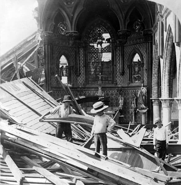 Three young men inside ruins of St. Patrick church, following a violent hurricane in the year 1900 which devastated Galveston and took more than 5,000 lives.