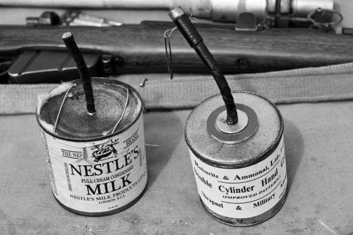 Left is a reproduction of the original Jam Tin Grenade, made literally from jam tins or condensed milk tins. Right the specially manufactured Double Cylinder Hand Grenade, based on the jam tin grenade.