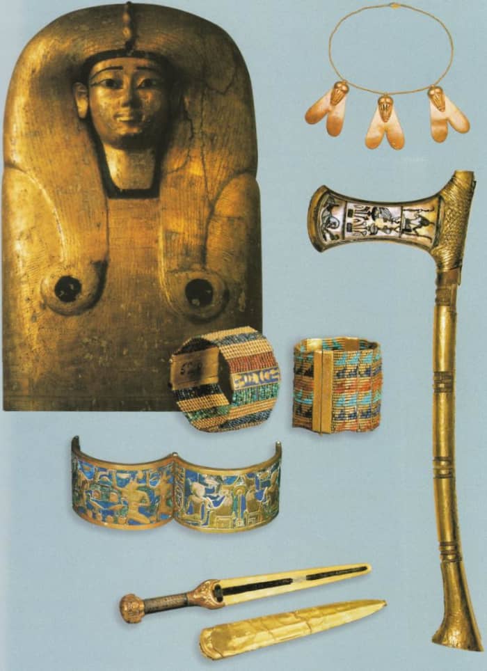 Figure 4: The coffin lid of Queen Ahhotep I, along with weapons and small trinkets recovered from the Queen's grave in the Dra Abu el-Naga tomb.