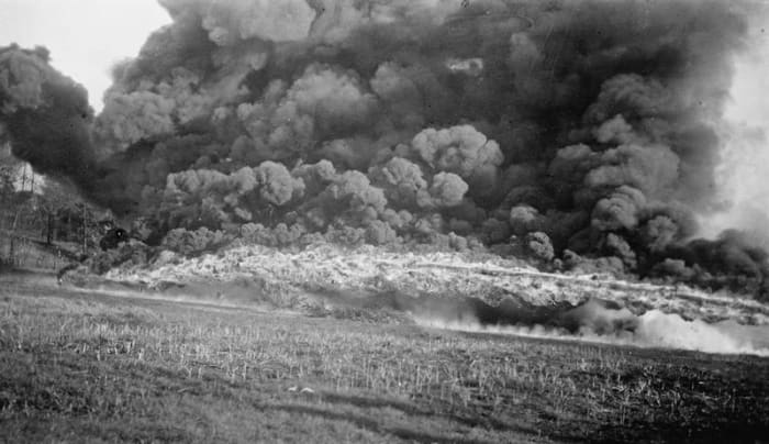 A British Livens Large Gallery Flame Projector (weighing 2.5 tons, 17 m long and requiring 300 men to assemble) shooting flaming oil 30 to 40 meters.