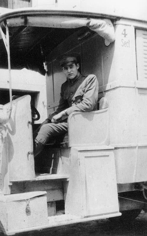 WW1: 19-year-old Ernest Hemingway in an American Red Cross Ambulance in Italy, 1918, reportedly taken near Caporetto. Despite being severely wounded, Hemingway continued helping Italian wounded, for which he received an Italian medal for bravery.