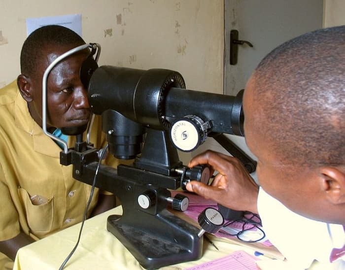 A patient being tested with a keratometer.