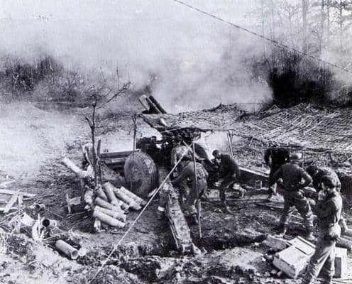 155mm gun section, Huertgen Forest 1944. Great example of crew members in action. The corporal gunner to the left of the breech and #1 gunner to the right. One of the loaders disposing of the casing. 3 ammo crew to the right. Section Sgt is on phone