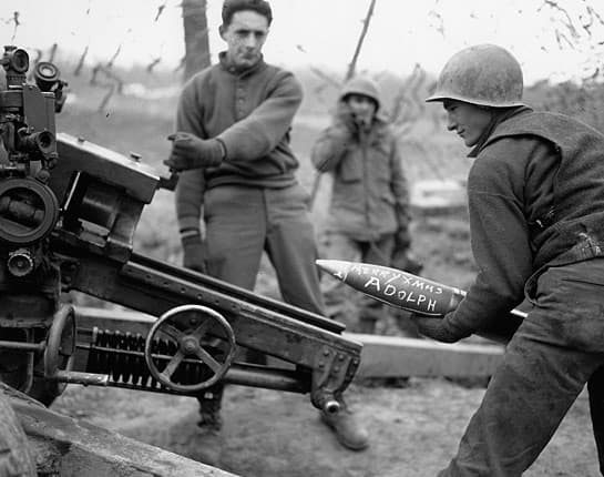 Although a staged photo, it does give a good view of the 105mm. You can see the #1 holding open the breech block, and the wheel that the gunner would use for deflection. There's also a great shot of the gunner's M12 panoramic scope.