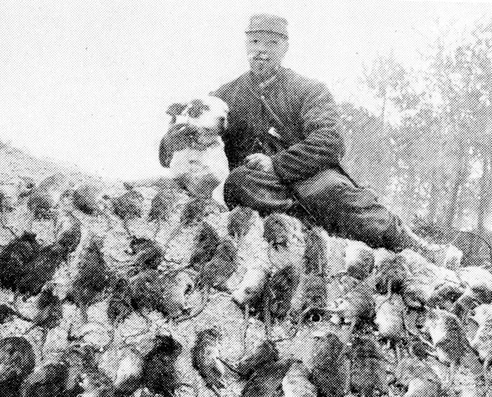 The war on the trench pest. Rat-hunter with a bag of rodents killed by the dog. These vermin infested some of the first-line positions in swarms, and were a source of great annoyance to the soldiers.