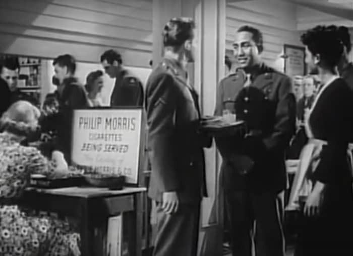 A black soldier along with a black hostess in the "Stage Door Canteen" movie