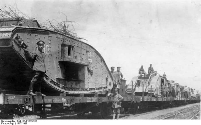 WW1: Captured British tanks ready for transport by rail to be refurbished and returned to the front. Circa 1917.