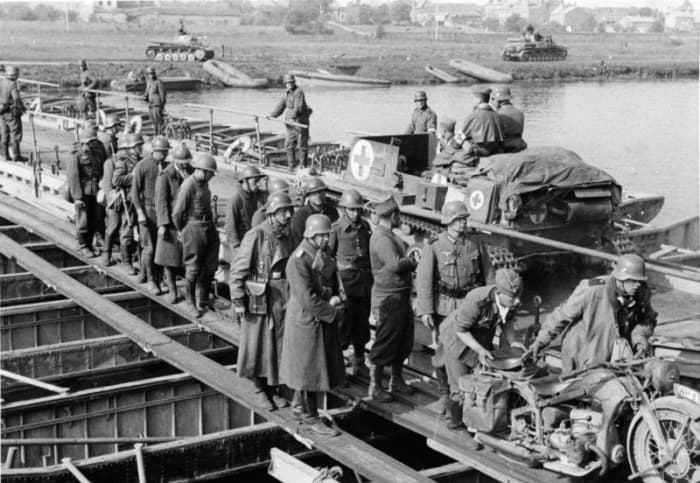 German tanks crossing the River Meuse somewhere near Sedan note French prisoners walking along the edge of the bridge.