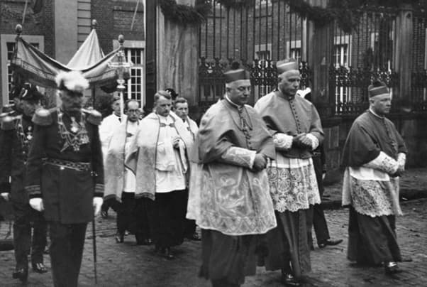 The bishop leads a Corpus Christi procession.