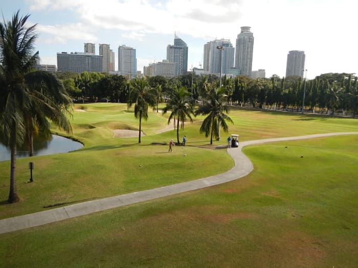 Intramuros golfclub with city skyline in background. About 2 million live in Manila today.