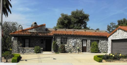 This historic California home has a few old orange trees lined in rows. The detached garage very much looks like it was done later, but it is a very good match. No one could be unhappy with it.