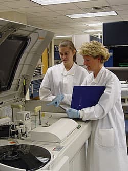 A typical analyzer in the chemistry department. Here you can see a new tech or maybe a student receiving some training. Every time the lab gets a new analyzer, we must go through training to learn how to use it.