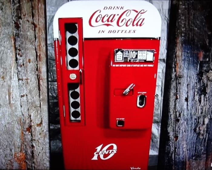 The ten cent coke machine dispensed glass bottles of soda. The handle released the mechanism allowing one bottle to be released.