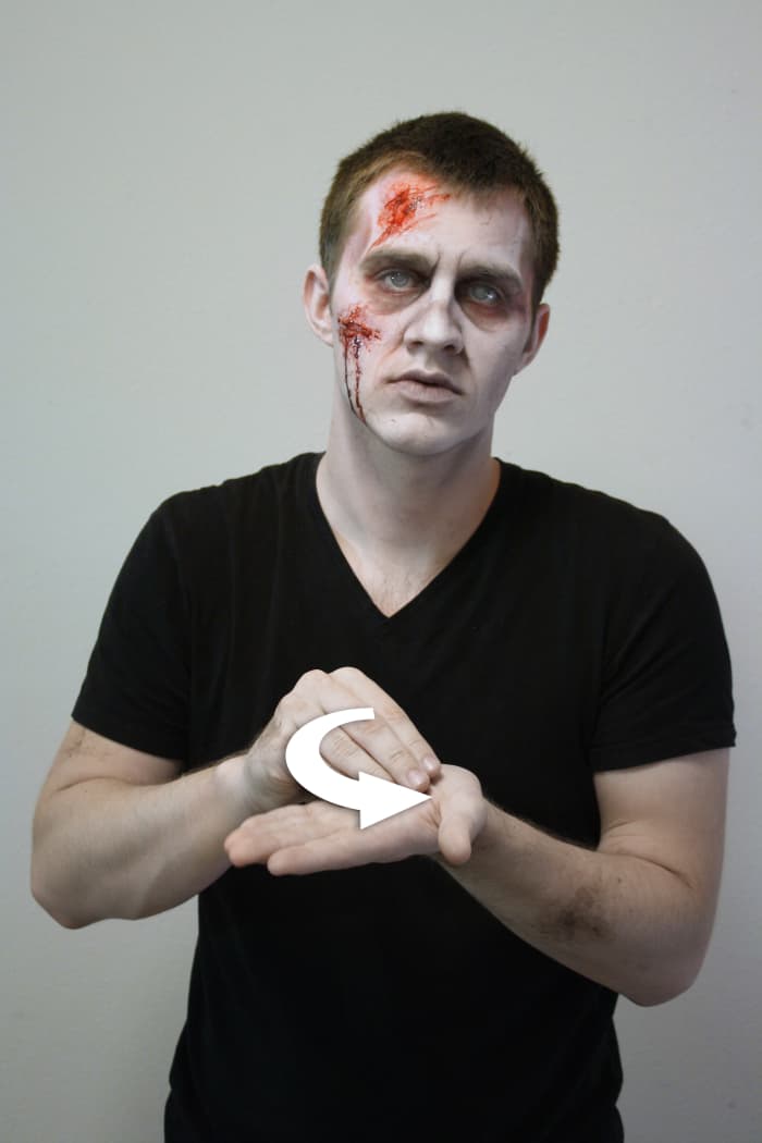 The non-dominant hand is held out palm open, then the dominant hand makes a circular motion with a flattened 'O' hand.