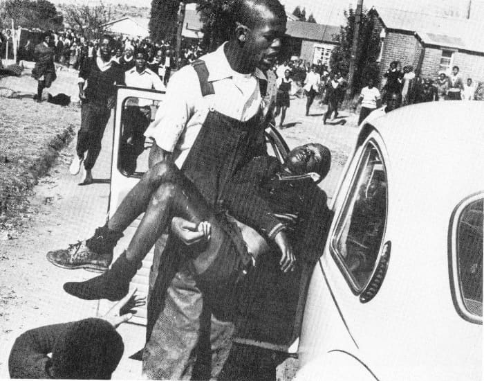 The famous picture of 12 year old Hector Petersen's limp body after having been shot by rogue cops carried by Mbuyiselo away from the carnage of the day - June 16th 1976