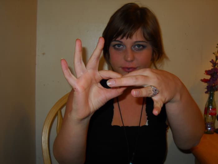 "Link/Connected": Make a loop with your index finger and your thumb on both hands. Open one just enough to close with another loop as you bring them together.