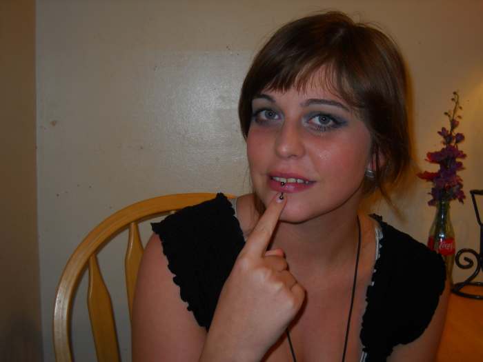 "Say": Put your index finger under your lip and bring it out.