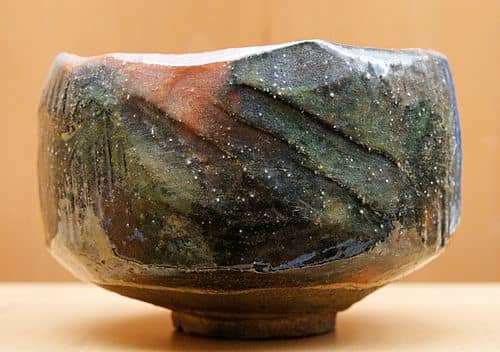 A red and black Raku chawan made by (and featuring the mark of) Ryonyu XI, potter of the 9th generation of Ryonyu potters. This piece is on display at the Musee des Beaux Arts de Lyon in Lyon, France.