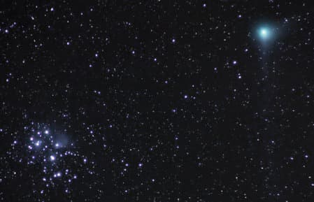 In this picture are two objects which can appear as fuzzy clouds in the night sky. A comet can be seen top right visually close to the loose star cluster known as The Pleiades.