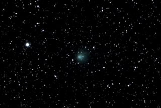 Encke's Comet. Occasionally a comet will become visible to the naked eye. Usually it will appear as a light smudge such as the comet in the centre of this image.