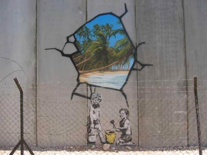 Image of hole in the wall, Israeli defensive barrier near Bethlehem Near 2005. Banksy's themes generally express ideas associated with left wing and anarchist beliefs, satirizing capitalism and established orders.