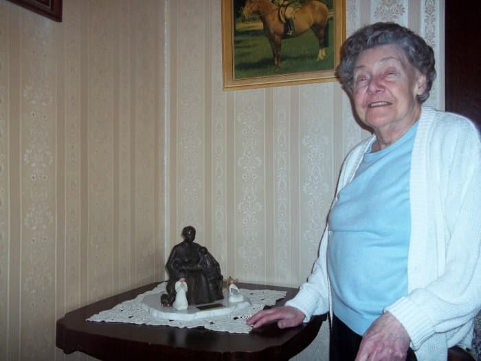 Muriel proudly displays a family heirloom...Rosa and her three children...created by Joyce McDonald...born a Casorso...and renowned sculptor.