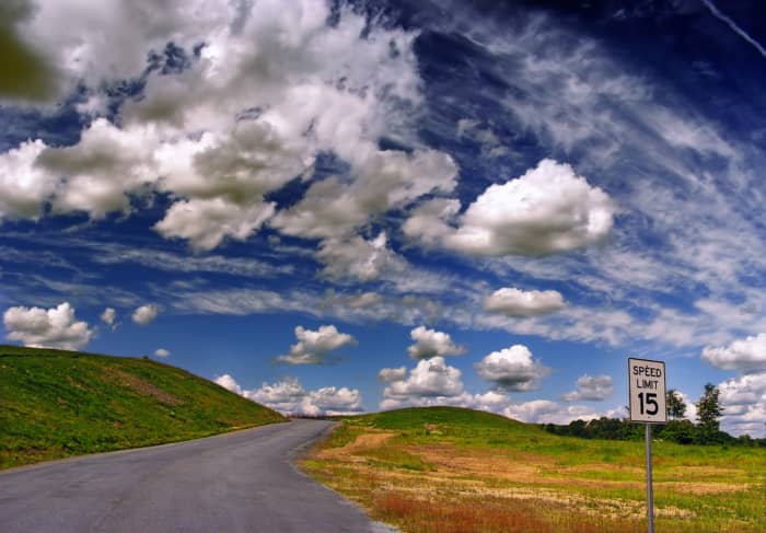 At any one time, there can be different kinds of clouds present. Here you can see puffy cumulus clouds set against a backdrop of cirrus clouds.